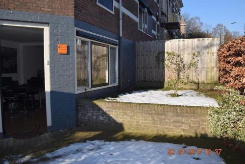 a house with snow on the ground next to a door at Arnhem Cosy center appartment in Arnhem