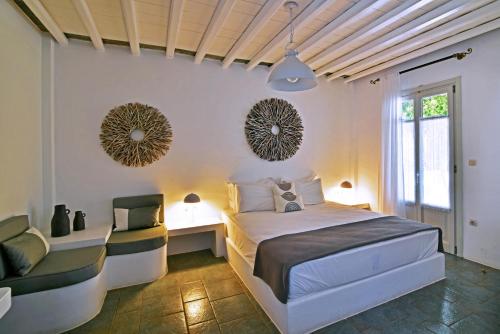 a bedroom with a bed and two mirrors on the wall at Myrto Bungalows in Artemonas