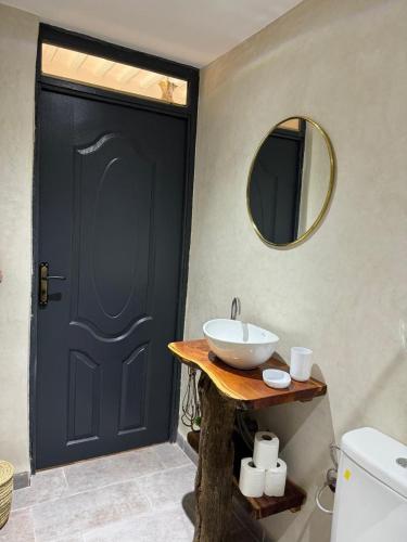 a bathroom with a black door and a sink at Cozy, Intimate Villa in Marrakech with Heated Swimming Pool Option in Touggana