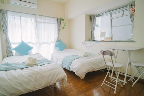 Ένα ή περισσότερα κρεβάτια σε δωμάτιο στο MinamiFukuokaHouse