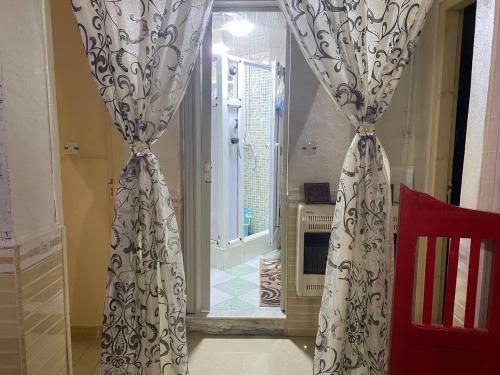 a living room with curtains and aoyer with a doorway at Cherchell Algeria Tipaza Apartment Rental in Cherchell