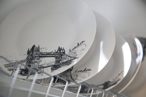 a pile of plates sitting in a dish rack at #2 Ioanna Apartments in Thessaloniki