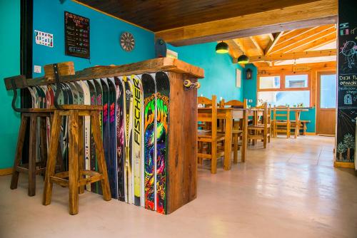 a bunch of snowboards lined up against a wall in a restaurant at Sherpa Hostel in San Martín de los Andes