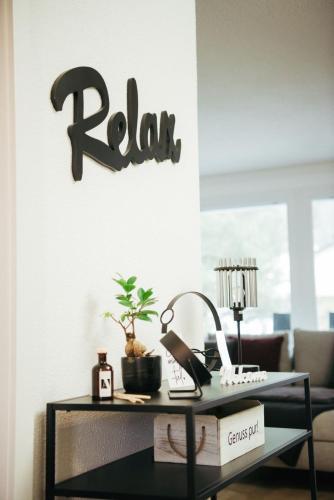a black table with a keyboard and arax sign on a wall at Feel Home Apartments 501 - Seeblick - Bergblick - Parkplatz in Emmetten
