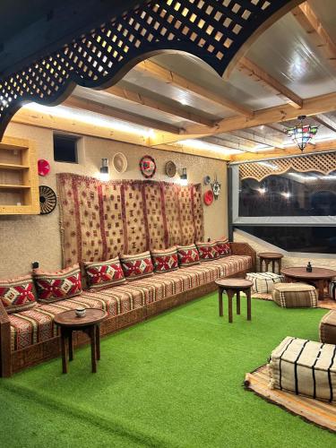 a living room with a couch and green carpet at Tirazir House 3 in Mirleft