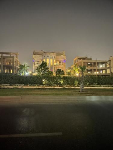a view of a city at night with buildings at modern villa with coverable pool sheik zayed in Sheikh Zayed