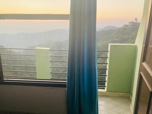 a room with a window with a view at Hotel D Pal in Kandāghāt