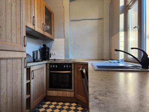 a kitchen with a sink and a stove top oven at Grafschaft in Jüterbog