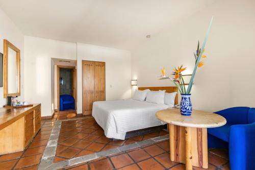 Ένα ή περισσότερα κρεβάτια σε δωμάτιο στο Hotel Rancho San Diego Grand Spa Resort