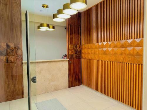 a bathroom with a shower and a glass door at Hotel Fratelli in Aguascalientes