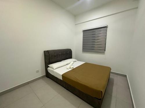 a bedroom with a bed in a room with a window at 168 KL Selayang Cottage Homestay in Batu Caves