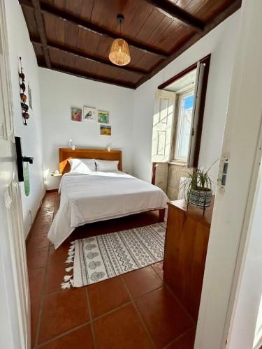 a bedroom with a bed and a window at Torre de Santiago - Guest House in Vila Praia de Âncora