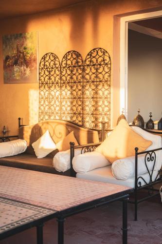 a room with three beds with pillows on them at Town Gate in Tamraght Ouzdar