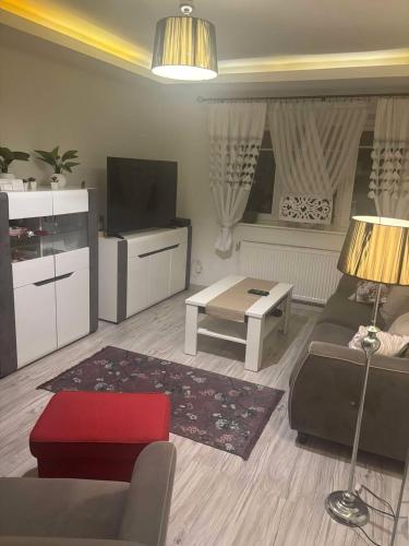 a living room with a couch and a tv at Mieszkanie niedaleko centrum in Gdańsk