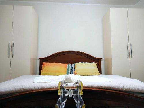 a bedroom with a bed with white cabinets at Stairway to Heaven in Shkodër