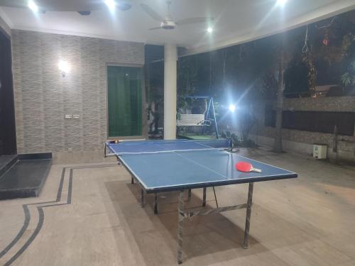 a ping pong table in a room with a ping pong ball at Fully Serviced Holiday Homes Near Emporium Mall & Expo Center in Lahore