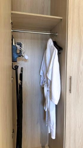 a closet with a towel hanging on a door at Golden Sayf AlUla in AlUla