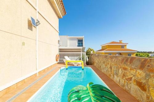 a swimming pool in the backyard of a house at Meloneras Hills Private Villa in Meloneras