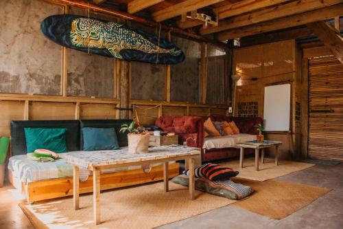 a living room with a table and a couch at Casa Austera in El Paredón Buena Vista