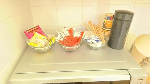 a table with four bowls of snacks on it at Room For Rent in Antwerpen in Antwerp