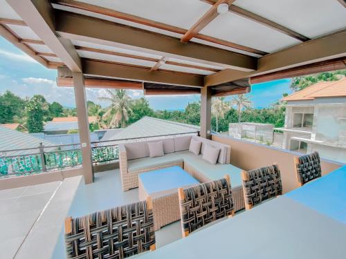 a patio with a table and chairs on a balcony at MeyGun House in Lovina