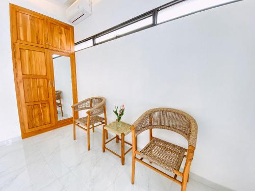 a room with two chairs and a table and a window at MeyGun House in Lovina