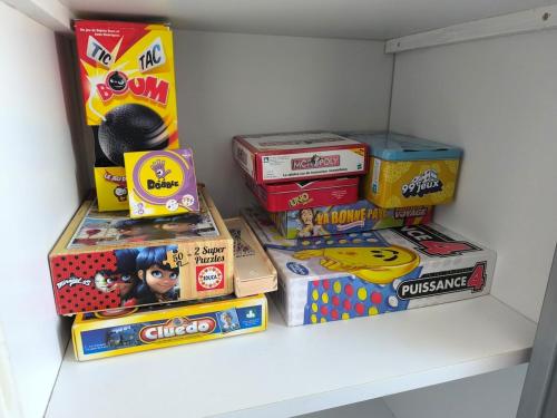 a pile of boxes sitting on a shelf in a closet at Le P'Tivoli - Maison centre historique in Clisson