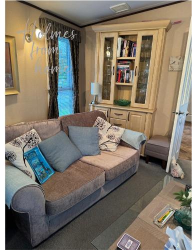 a living room with a couch with pillows on it at Holmes from Home - 106 Sunrise Southview in Winthorpe