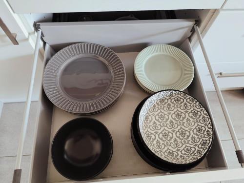 three plates are sitting in a drawer at Le P'Tivoli - Maison centre historique in Clisson
