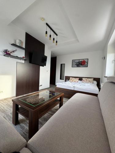 a living room with a couch and a coffee table at Apartman Panorama 1001 in Štrbské Pleso