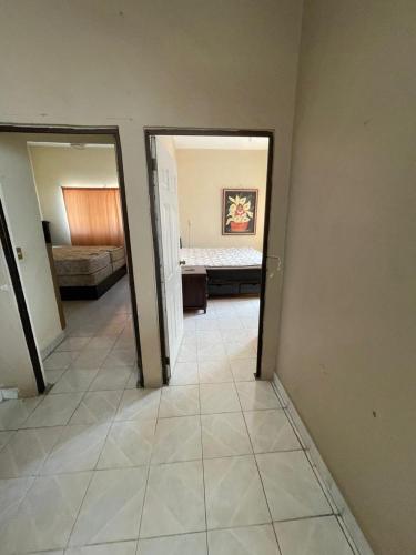 a hallway with a room with a bed and a bedroom at Apartamento Ocosingo in Ocosingo