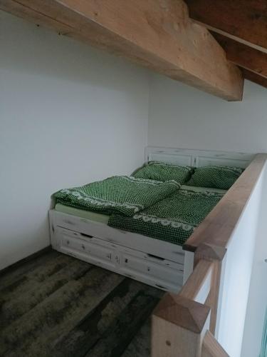 a bedroom with a bed in a room with a staircase at Ubytování Na potoce in Radvanice