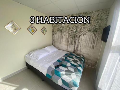 a small bed in a room with the words retribution at casa de playa vacacional goldsky in Vista Alegre