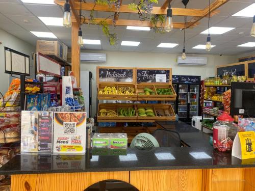 a grocery store with a counter with fruits and vegetables at casa de playa vacacional goldsky in Vista Alegre
