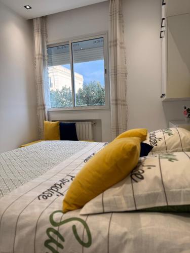 a bedroom with a large yellow pillow on a bed at Most charming apartment in la Marsa in La Marsa