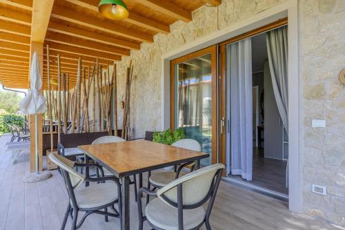 a wooden table and chairs on a patio at Villa Maddalena in Bardolino