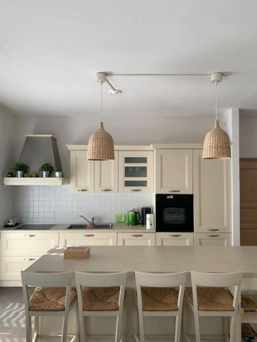 a white kitchen with a table and chairs at Appartamento caneve in Arco