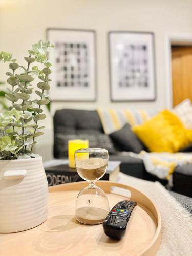 a glass of wine on a table with a remote control at Lethbridge Villa 49 Apartment 2 Super Fibre WiFi, free parking in Southport