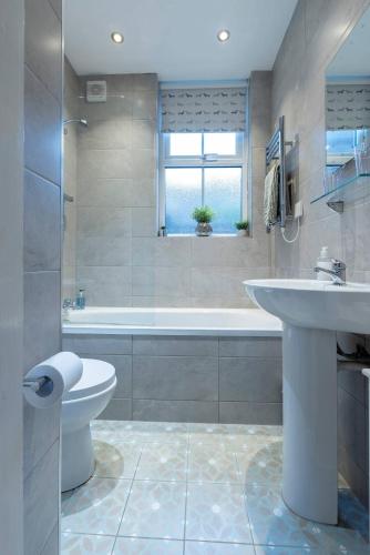 a bathroom with a tub and a sink and a toilet at Bootham Apartment 32 - Free Parking - Five minute walk to York Minster in York