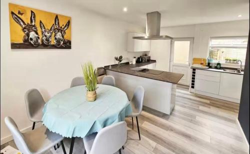 a kitchen and dining room with a table and chairs at 3 Stars Grètopp house in Little Hulton