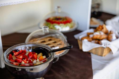 a table with a bowl of fruit and a bowl of food at Villa Maddalena in Bardolino