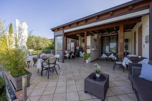 a patio of a restaurant with tables and chairs at Villa Maddalena in Bardolino