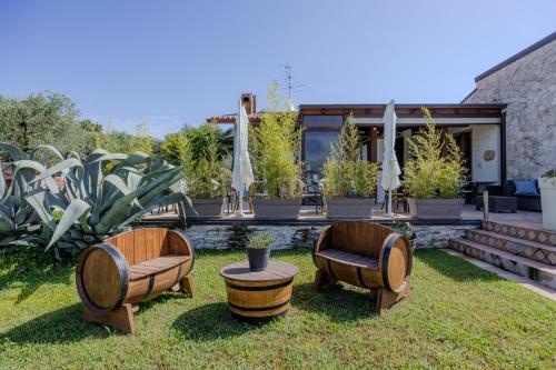 two chairs and a table in a yard at Villa Maddalena in Bardolino