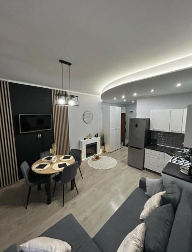 a living room with a couch and a table at Landsberg Studio Apartment in Górowo Iławeckie