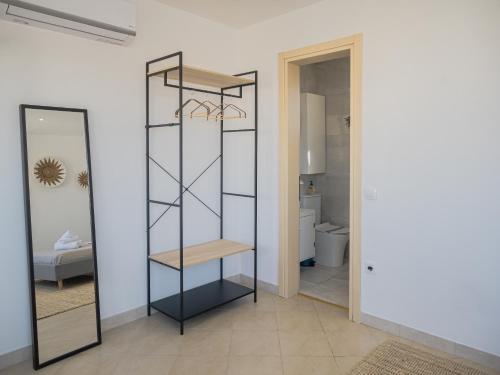 a bathroom with a mirror and a toilet at Casa Acropolis - Stunning 3Br Apt with Private Terrace in Athens