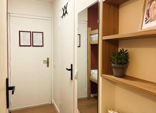 a hallway with a white door and a closet at BÈTH CÈU - 4 PERS - Appart vacances- in Arette