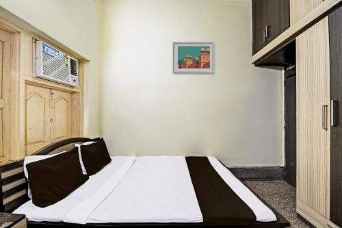 a bedroom with a bed in a room at Hotel O Arati House in Kolkata