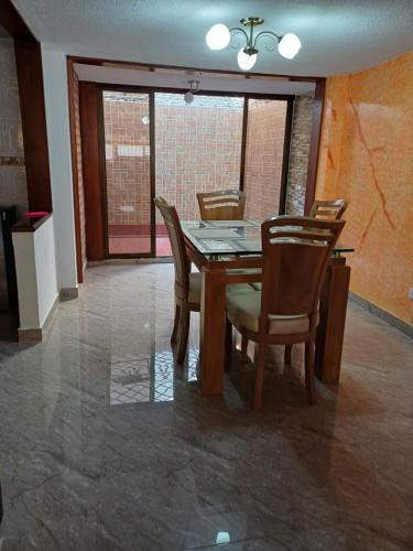 a dining room with a wooden table and chairs at El Palmar in Palmira