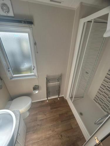 a bathroom with a toilet sink and a shower at The Brend - Seaview holiday home in Newbiggin-by-the-Sea
