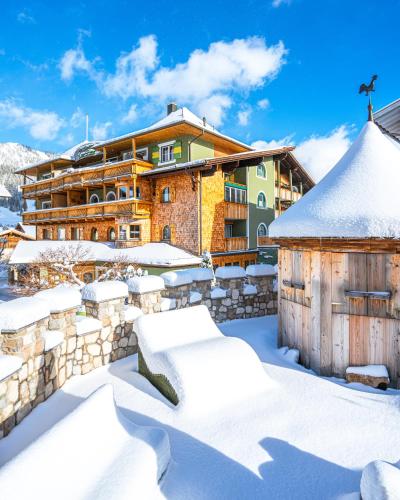a resort in the snow with snow covered buildings at Hotel "Zum Ritter" in Tannheim